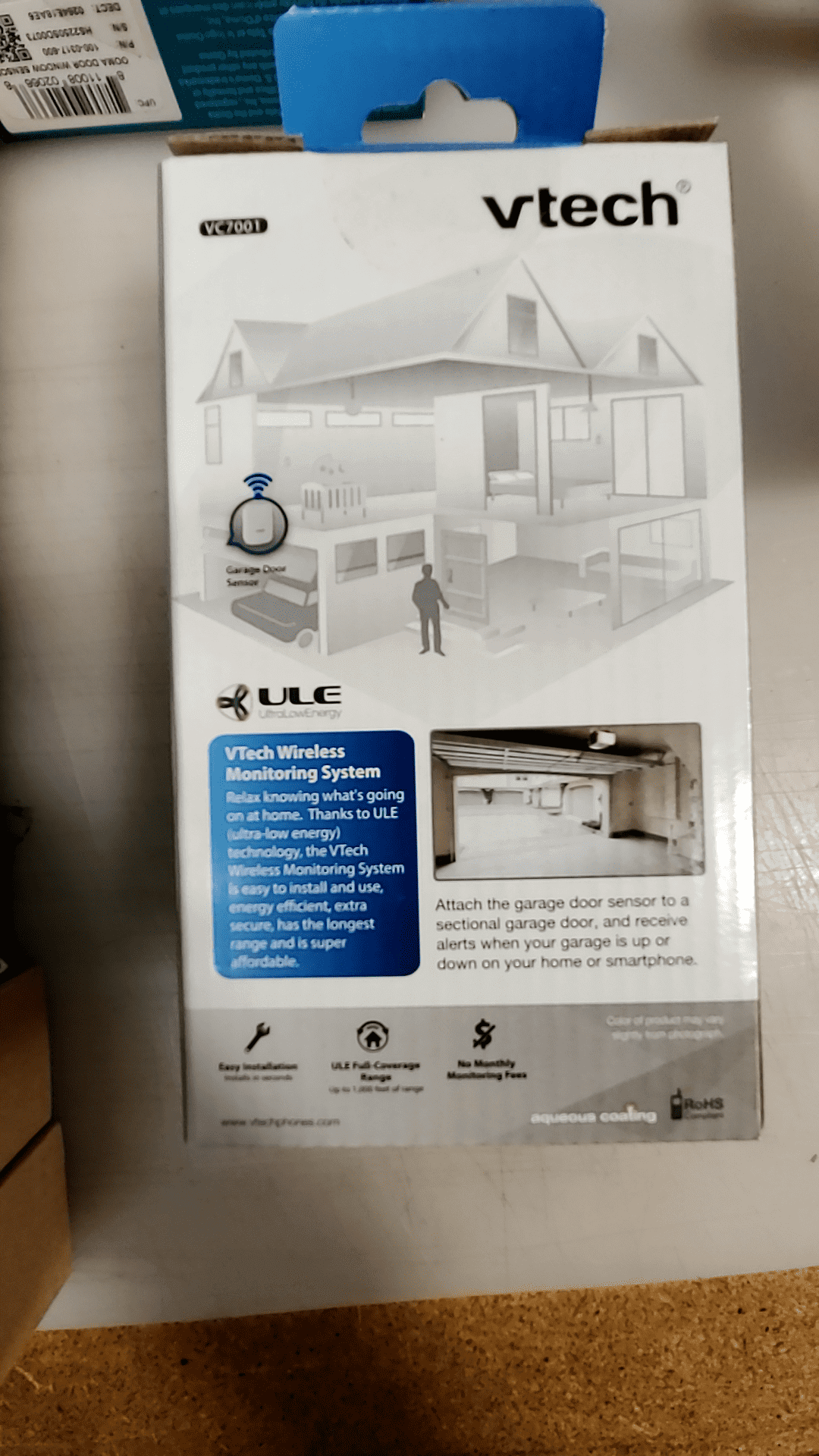 VTech Wireless Monitoring System packaging showing features for garage door security.